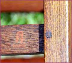 Red decal signature and pinned mortise & tenon joint at rear of chair. 